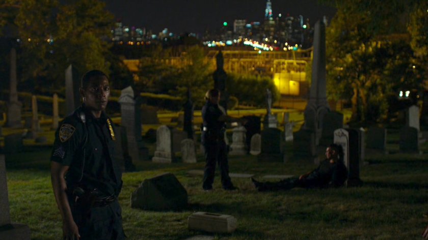 Police officers arresting Frank in St. Michael's Cemetery.
