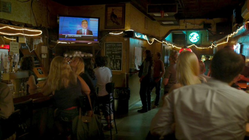 Patrons of Josie's Bar watch the news.