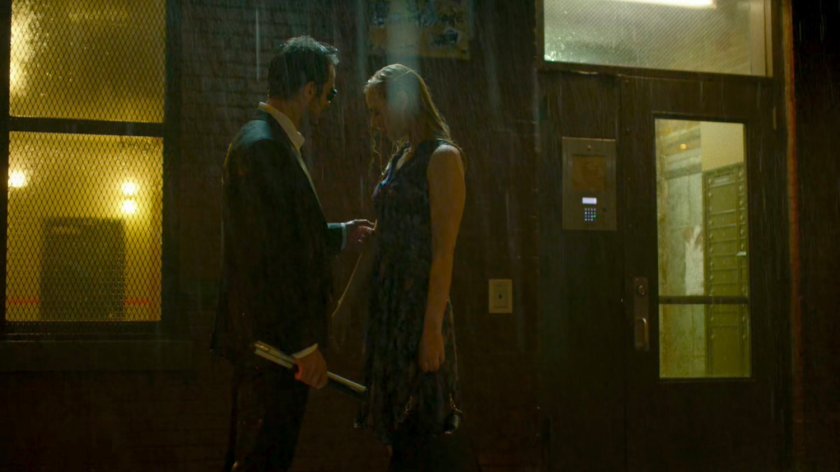 Matt and Karen standing in rain, outside Matt's apartment.