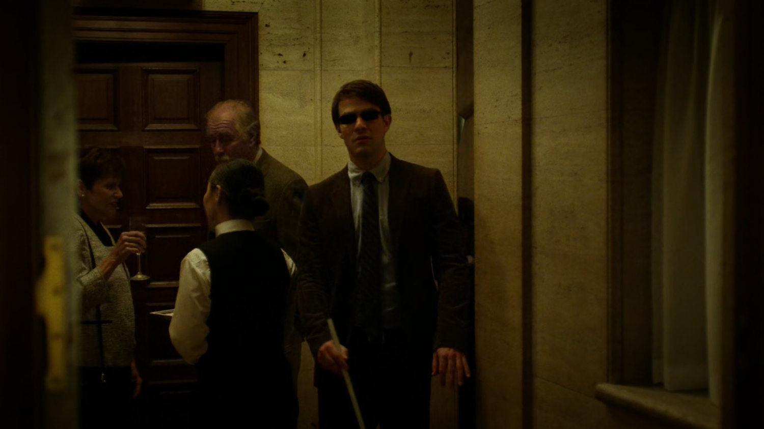 Matt walks through a crowded faculty party.
