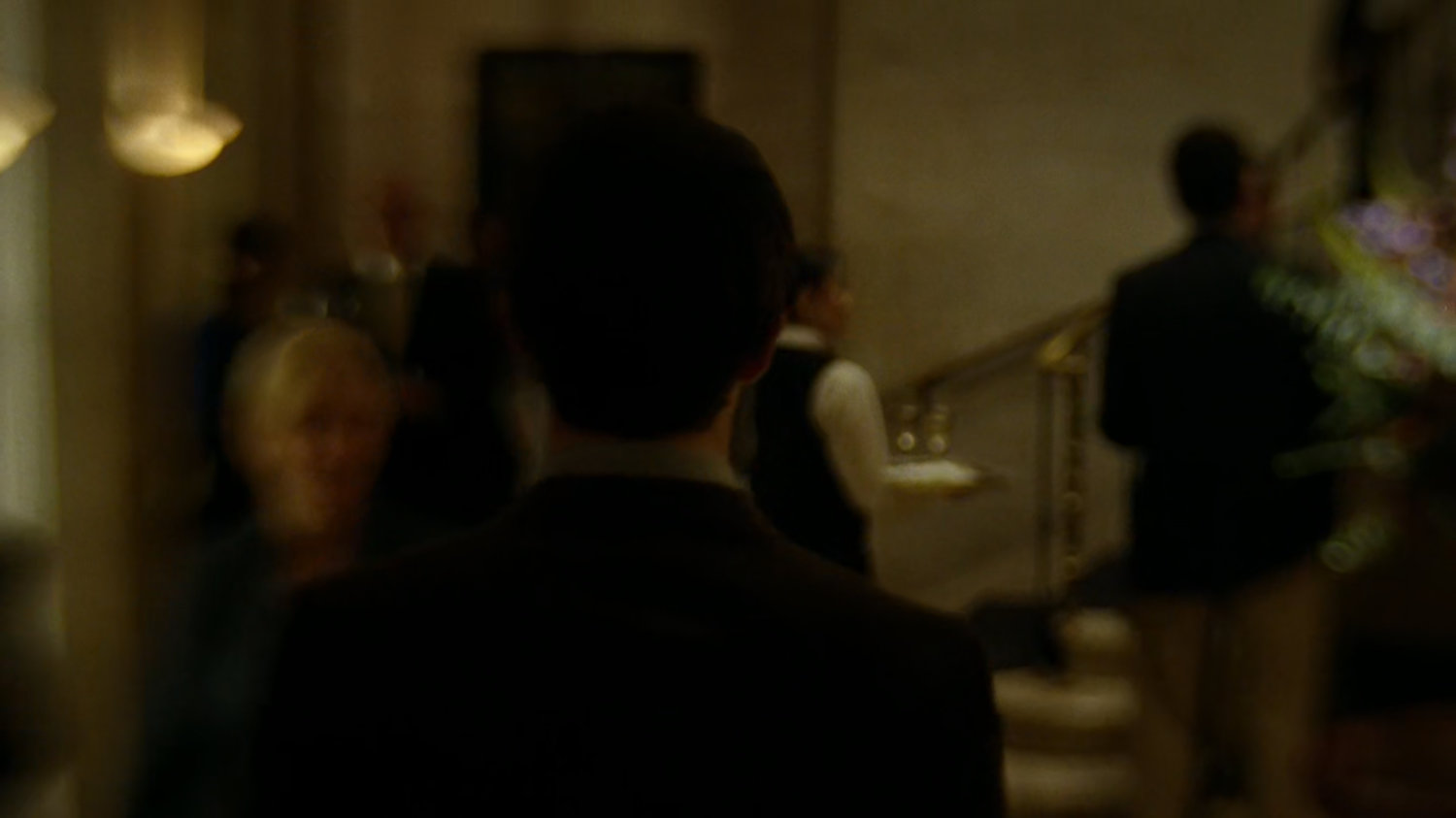 Matt walks through a crowded faculty party.