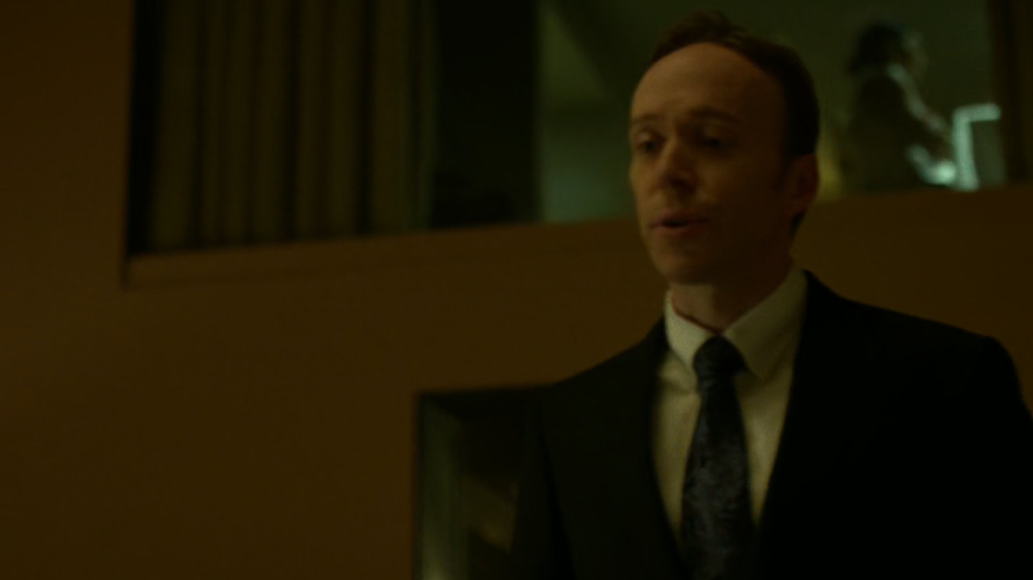 The maitre'd speaks to Matt at a fancy restaurant.