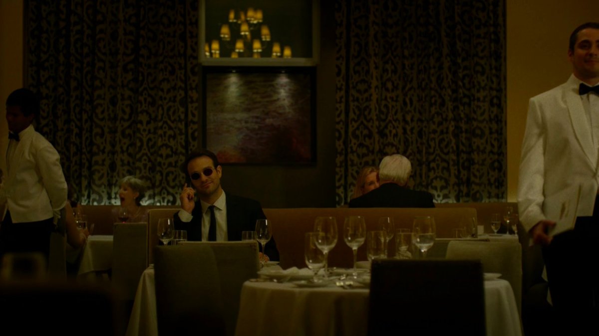 Matt on the phone at a fancy restaurant.