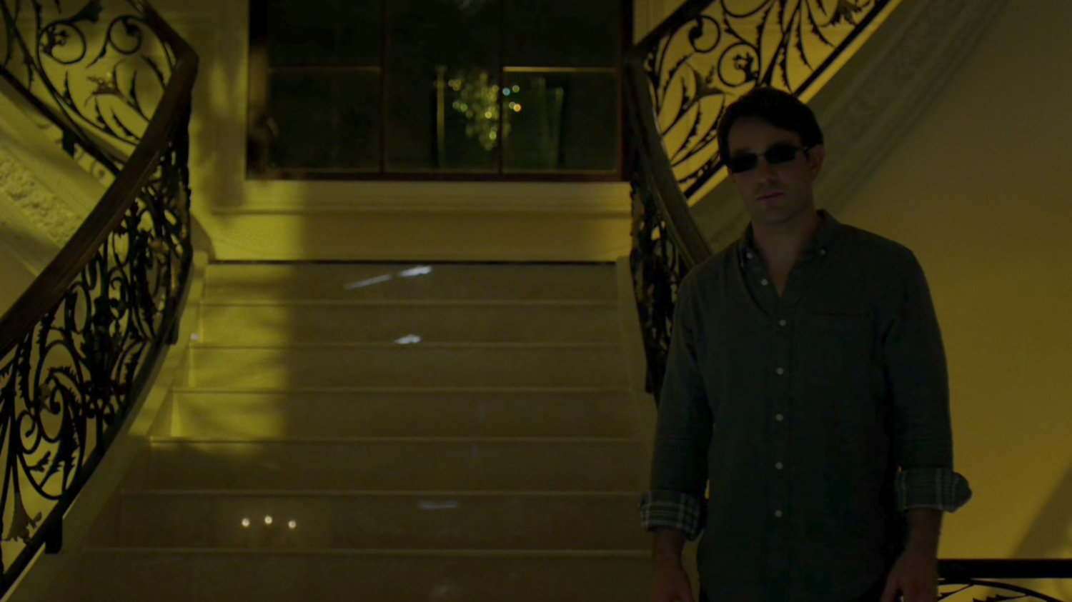 Matt standing in the foyer of Roscoe Sweeney's mansion.