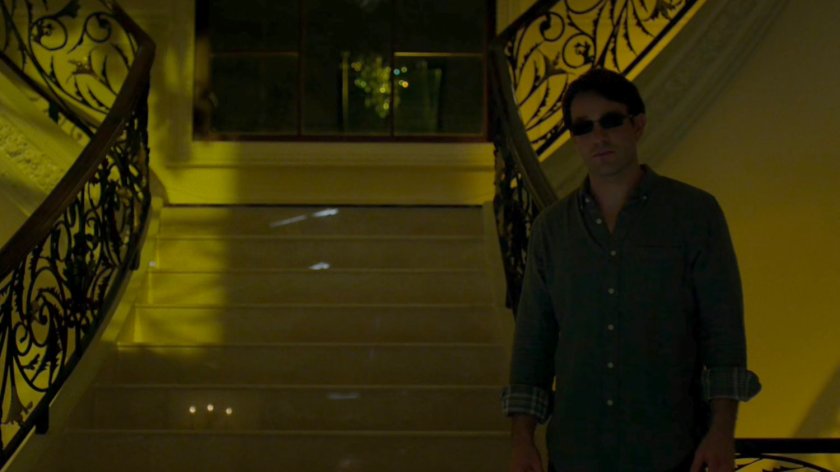 Matt standing in the foyer of Roscoe Sweeney's mansion.