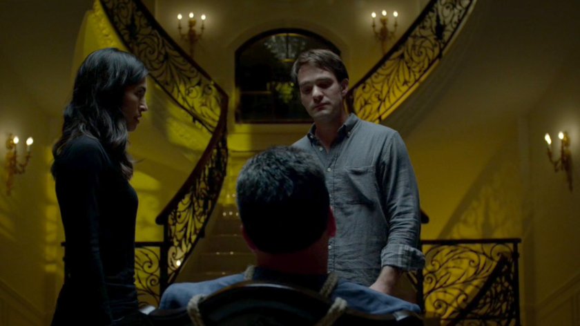 Matt and Elektra standing by Roscoe Sweeney, who is tied up at his mansion.