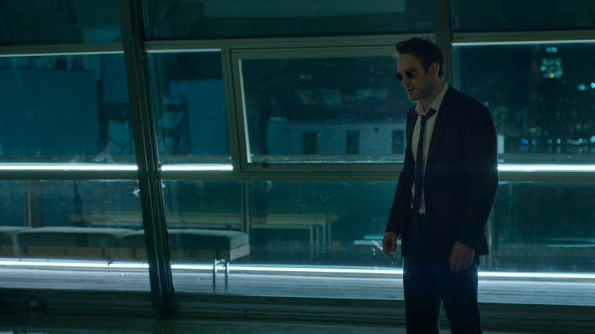 Matt standing by the window in Elektra's penthouse.