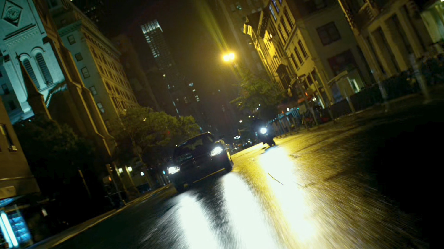 A Yakuza motorcycle rider cruises through a New York street.