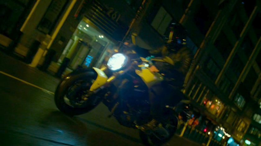 A Yakuza motorcycle rider cruises through a New York street.