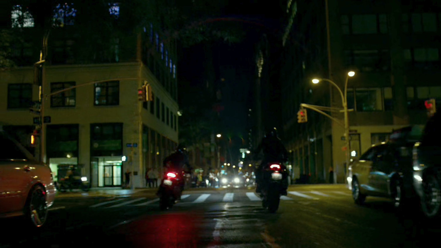 A pair of Yakuza motorcycle riders cruise through a New York street.