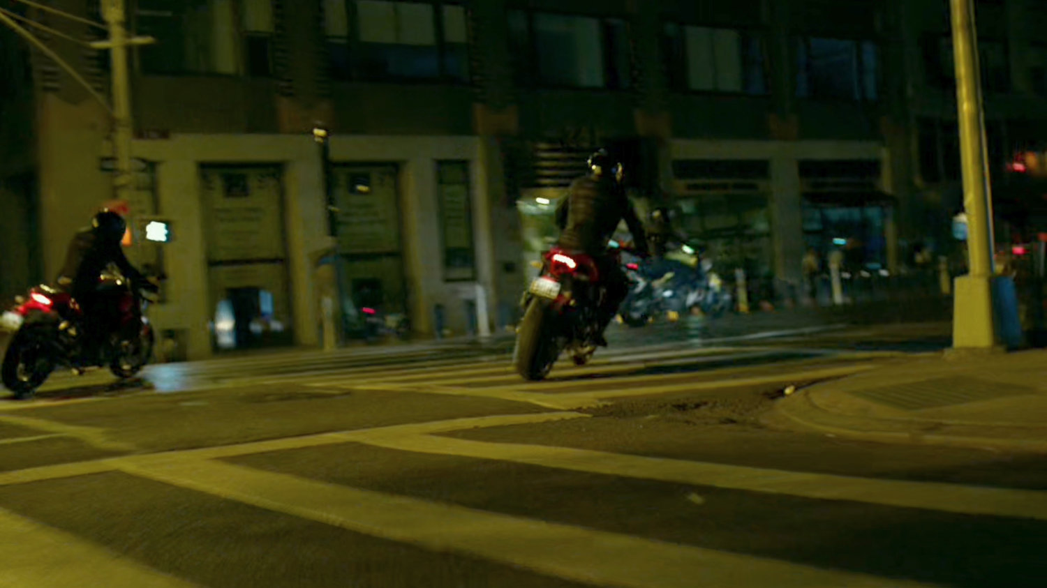 A pair of Yakuza motorcycle riders cruise through a New York street.