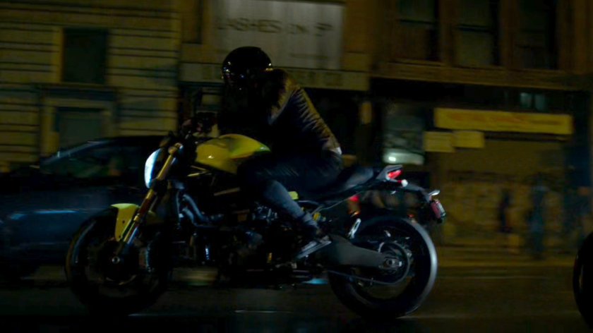 A Yakuza motorcycle rider cruises through a New York street.
