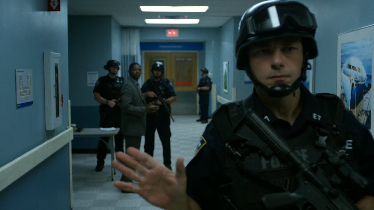 An armed SWAT members stops people getting off the 5th floor elevator at Metro-General.