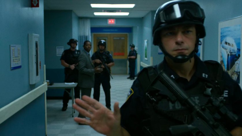 An armed SWAT members stops people getting off the 5th floor elevator at Metro-General.