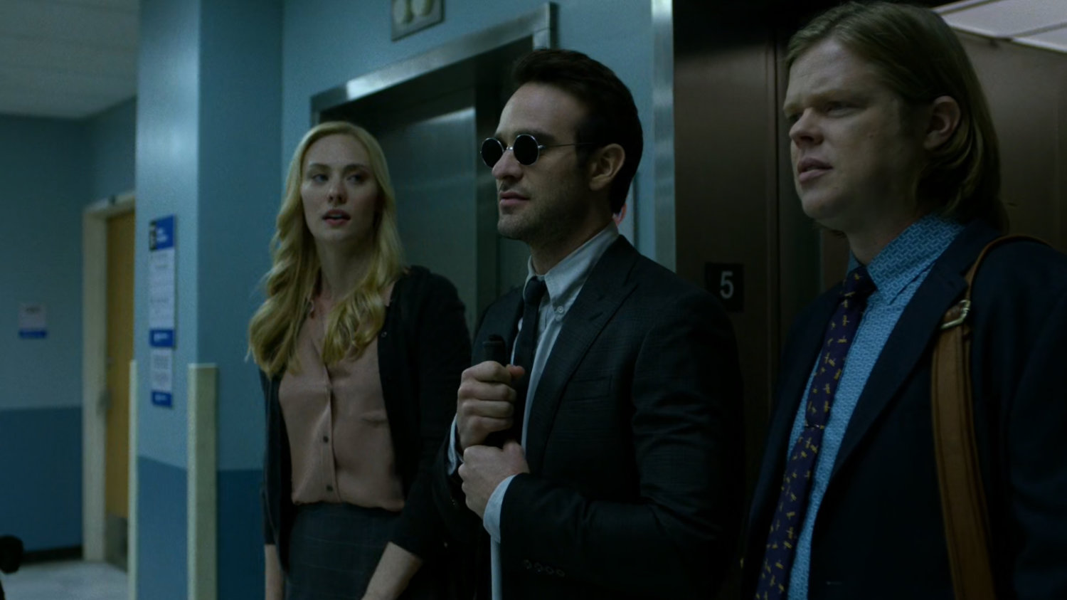 Karen, Matt, and Foggy existing the elevator on the 5th floor of Metro-General Hospital.