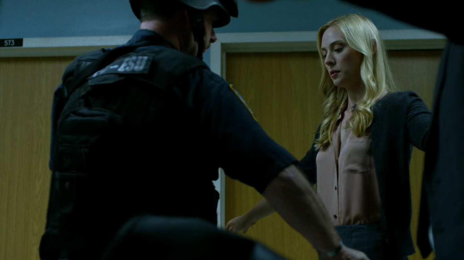 Karen goes through a security sweep outside Frank Castle's Metro-General Hospital room.