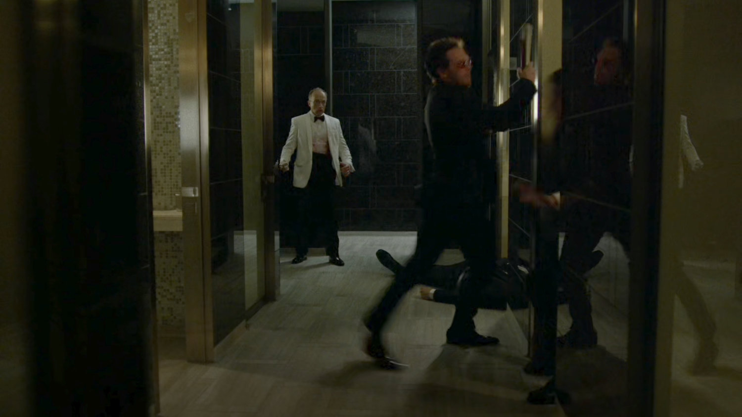 Matt knocks out Asano security guards in the Roxxon Gala bathroom.
