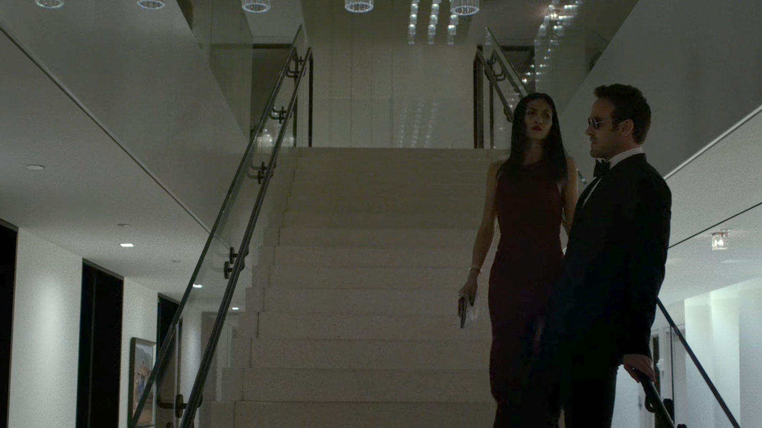 Matt and Elektra on stairs on the 13th floor of the Yakatomi Building.