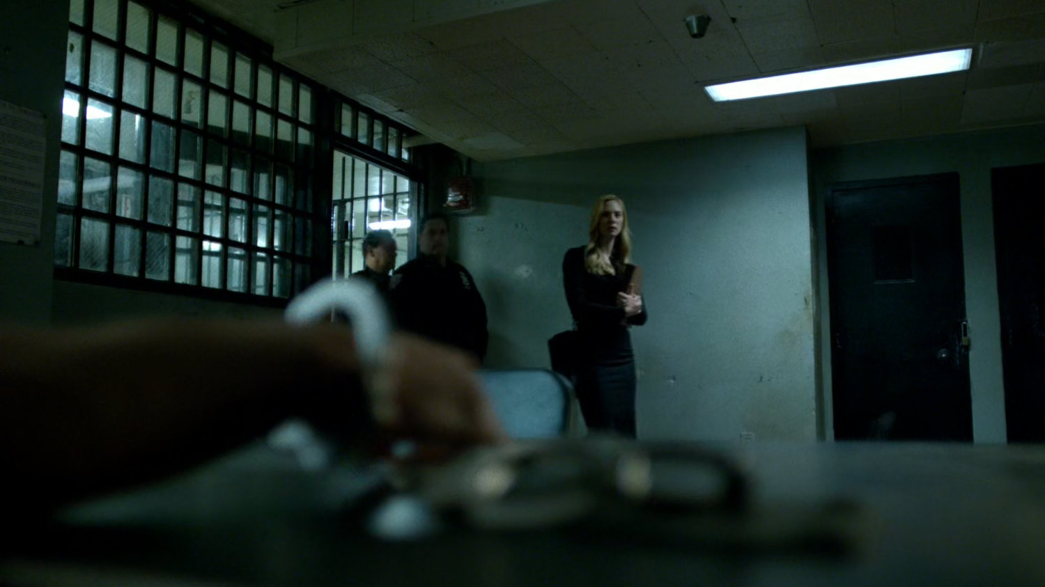 Karen entering conference cell with Frank Castle chained up.