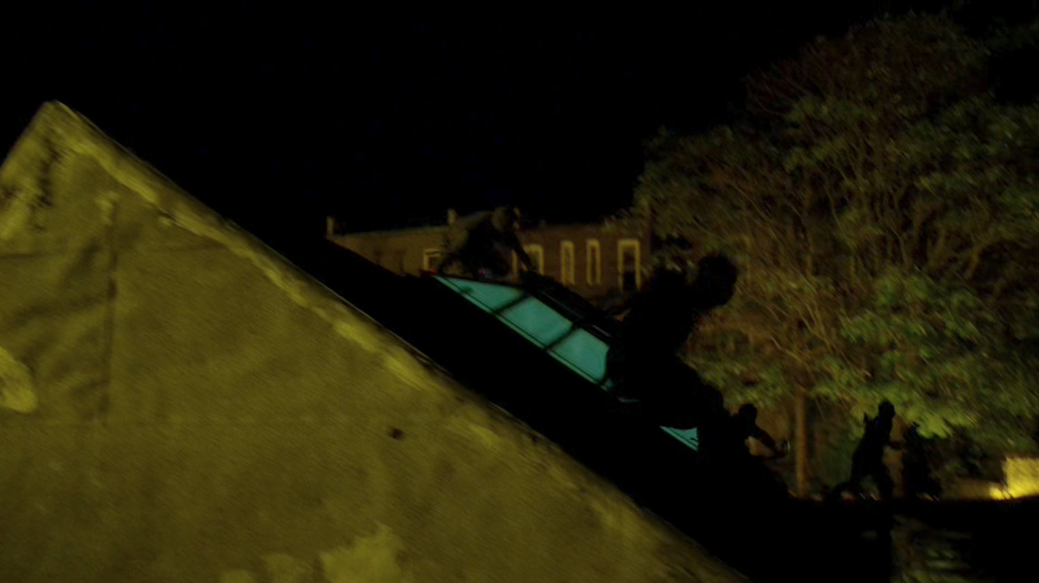 Ninjas from the Hand run across the rooftops at night.