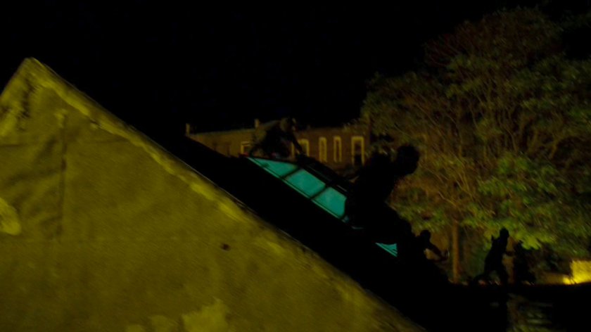 Ninja's from the Hand run across the rooftops at night.