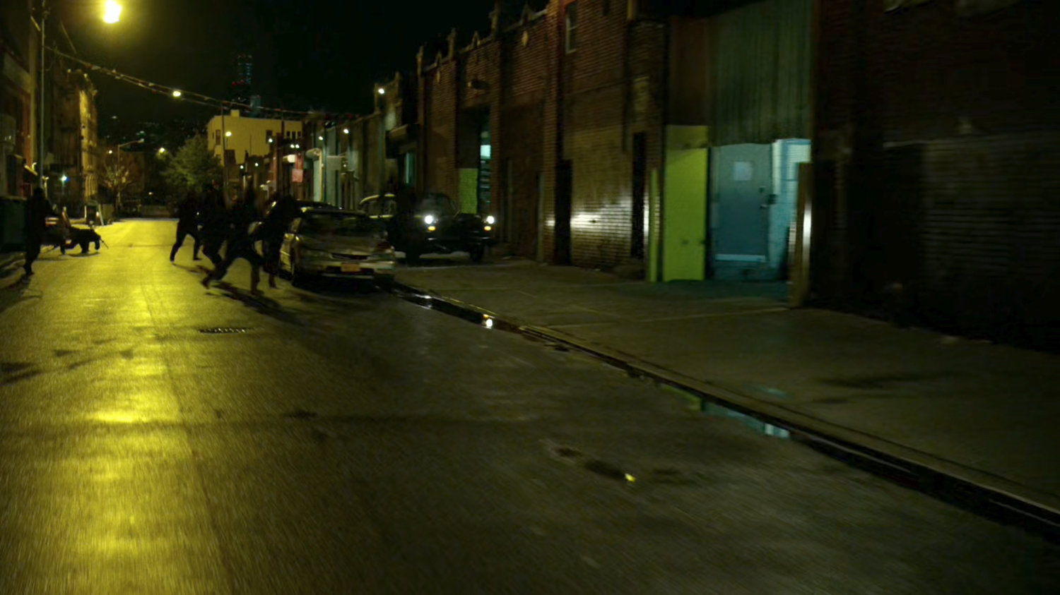 The Hand ninjas chase Stick's car along street at night.