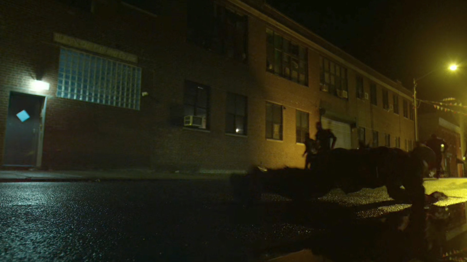 The Hand ninjas run along street at night.