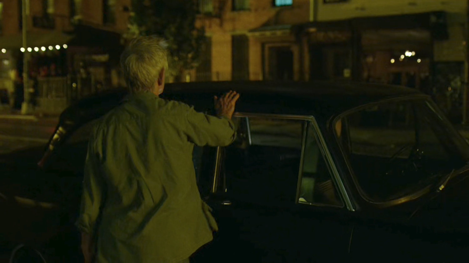 Stick gets into a car outside Matt's apartment building.