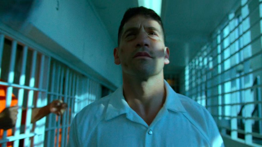Frank walking along prisoner hallway in Ryker's Island correctional facility.