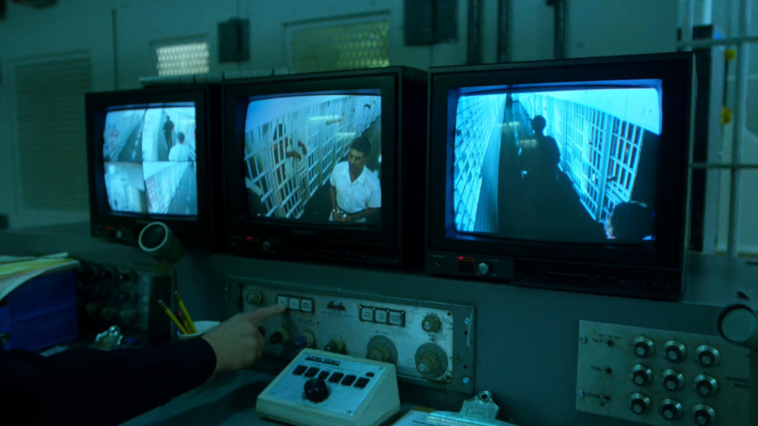 Security station with monitors showing Frank Castle in Ryker's Island correctional facility.