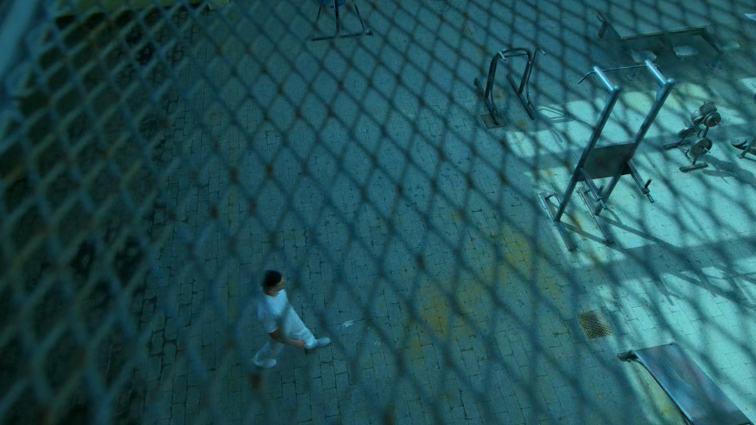 Frank walking into prison yard at Ryker's Island correctional facility.
