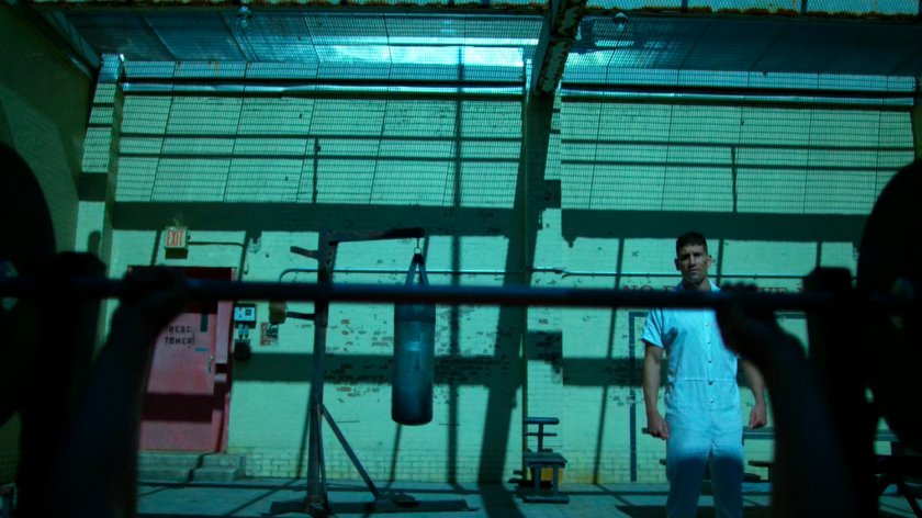 Frank watching Wilson Fisk in prison yard of Ryker's Island correctional facility.