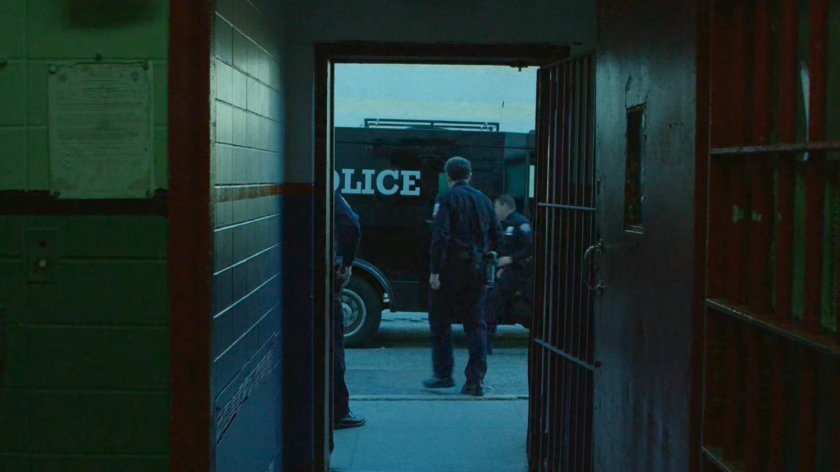 Police wagon outside entrance door to Ryker's Island correctional facility.