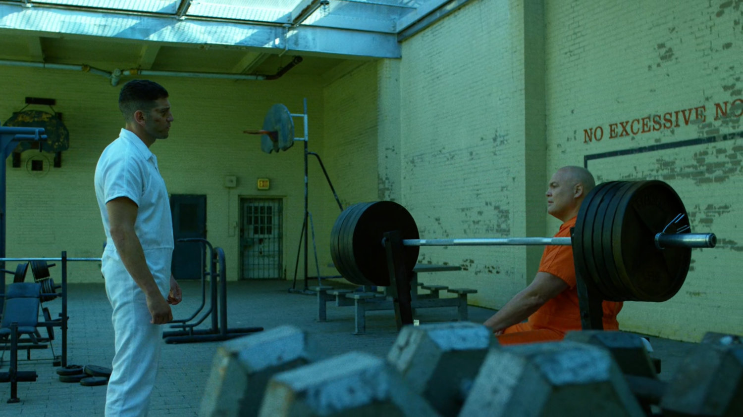 Frank talking to Wilson Fisk in prison yard of Ryker's Island correctional facility.