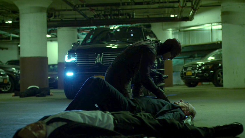 Daredevil threatening Stan Gibson in Yakatomi parking garage.