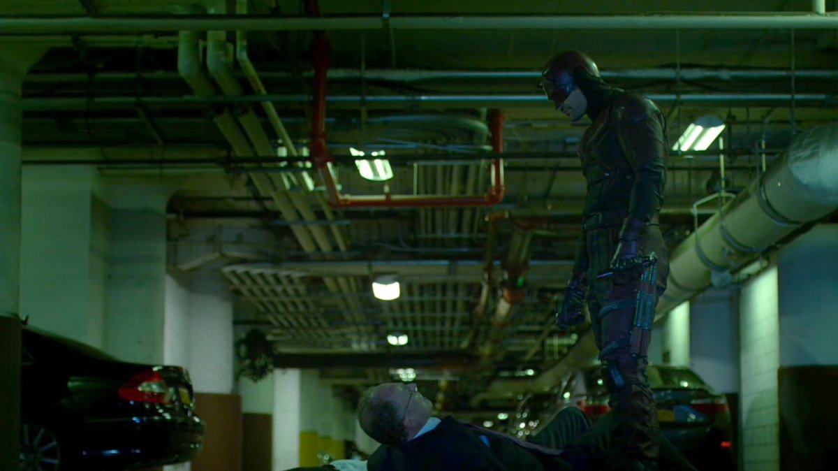 Daredevil threatening Stan Gibson in Yakatomi parking garage.
