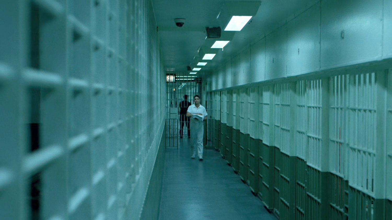 Frank walking through cellblock at Ryker's Island correctional facility.