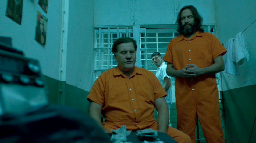 Frank approaching Dutton's cell at Ryker's Island correctional facility.