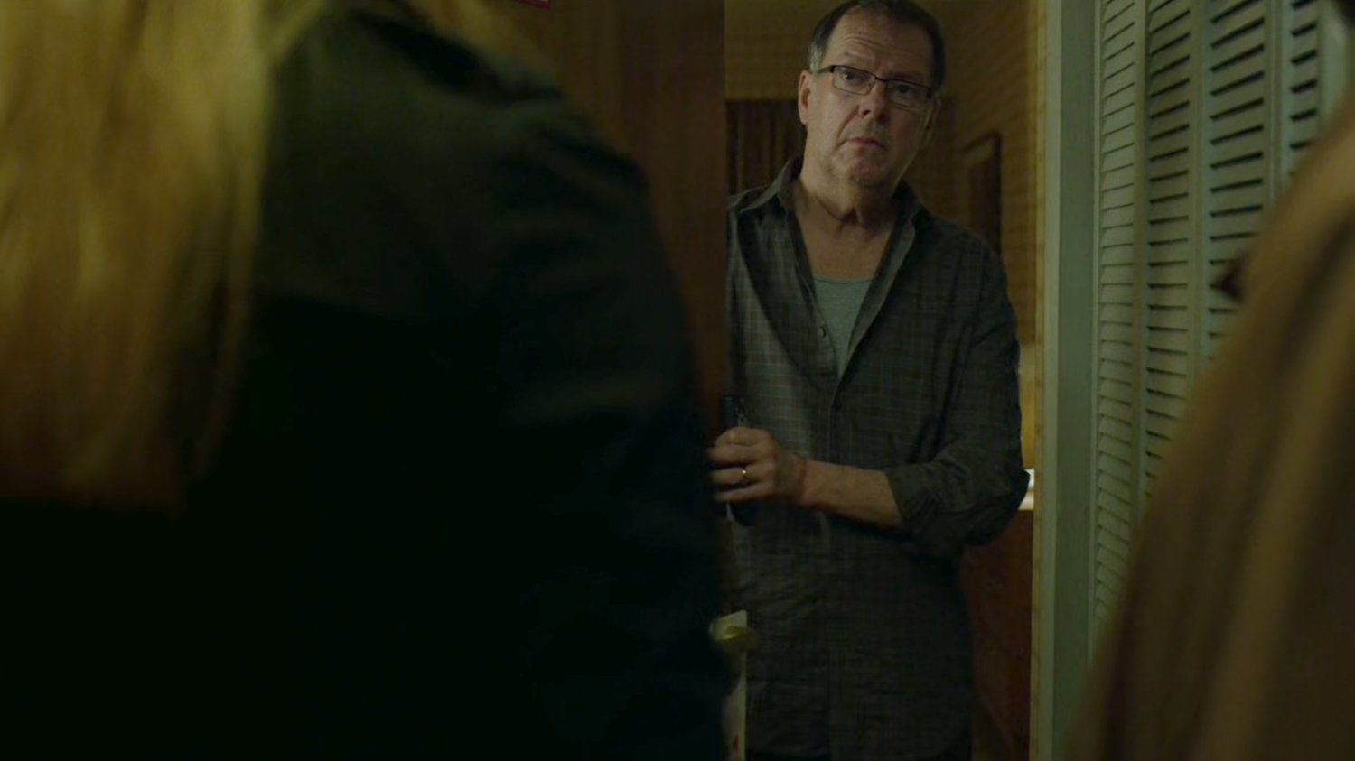 Doctor Tepper answering the door to his motel room.