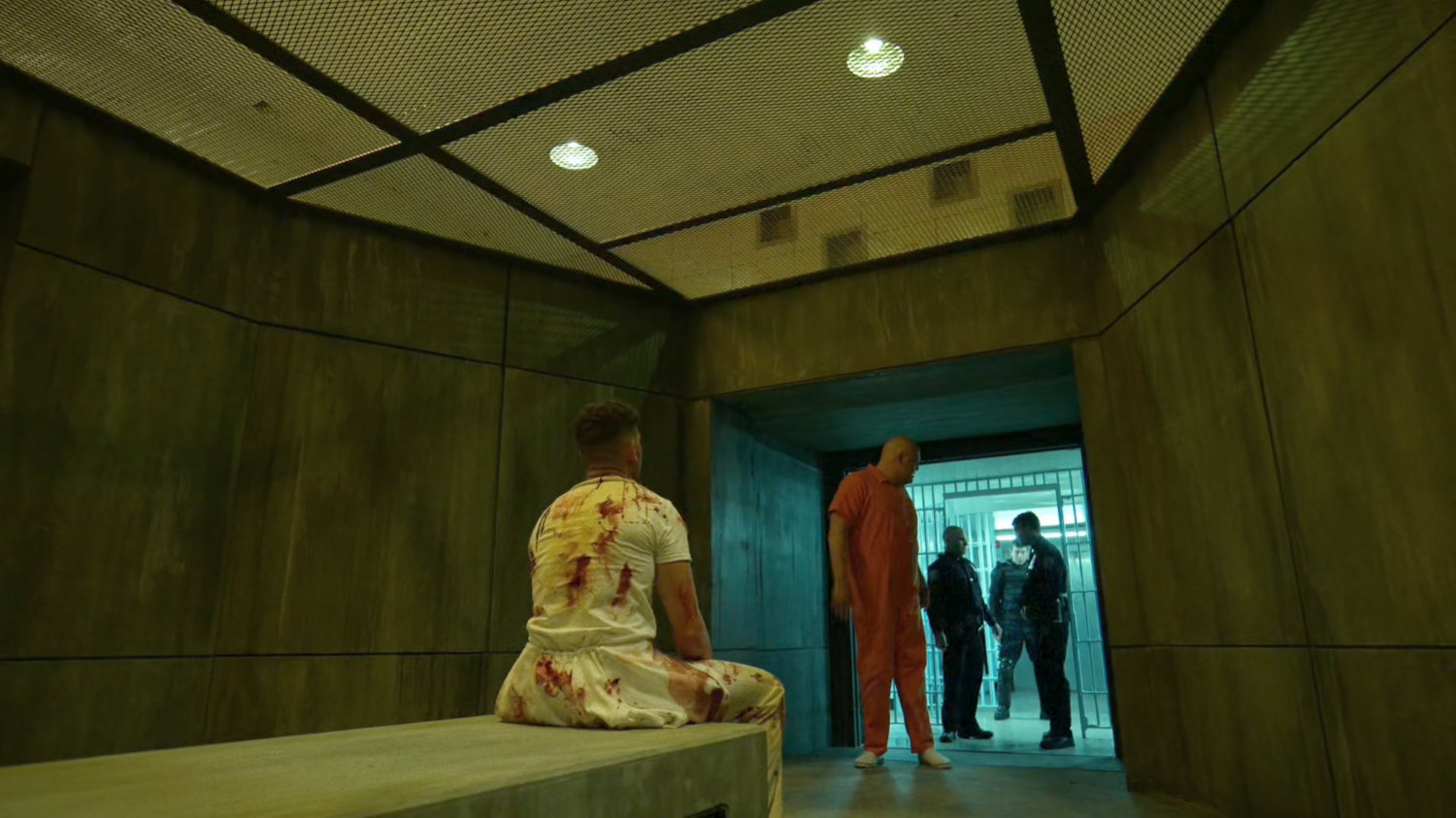 Fisk approaches Frank in a solitary room at Ryker's Island correctional facility.