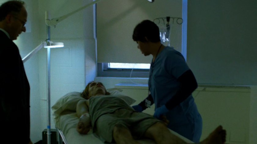 Nurse examining an "infected" patient in a remodeled wing of Metro-General.