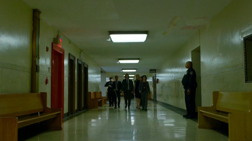 Matt, Karen, and Foggy led by police down a hallway in the courthouse.
