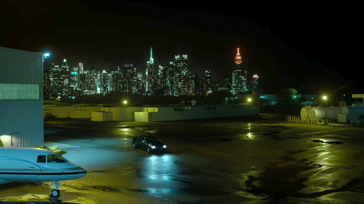 A car at a private airplane hangar.