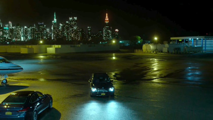 A car at a private airplane hangar.