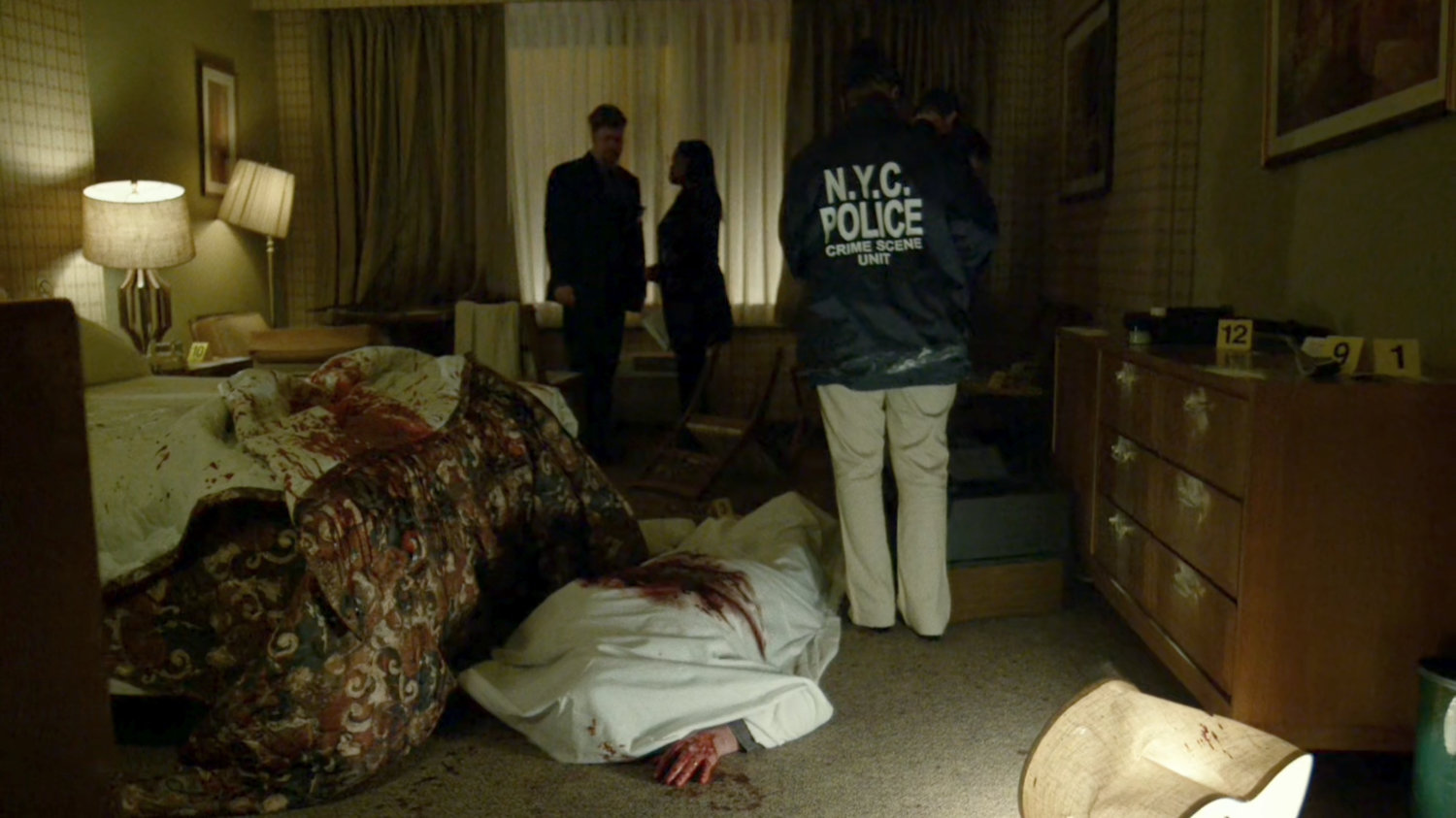 Officers and crime scene analysts inside Tepper's motel room.