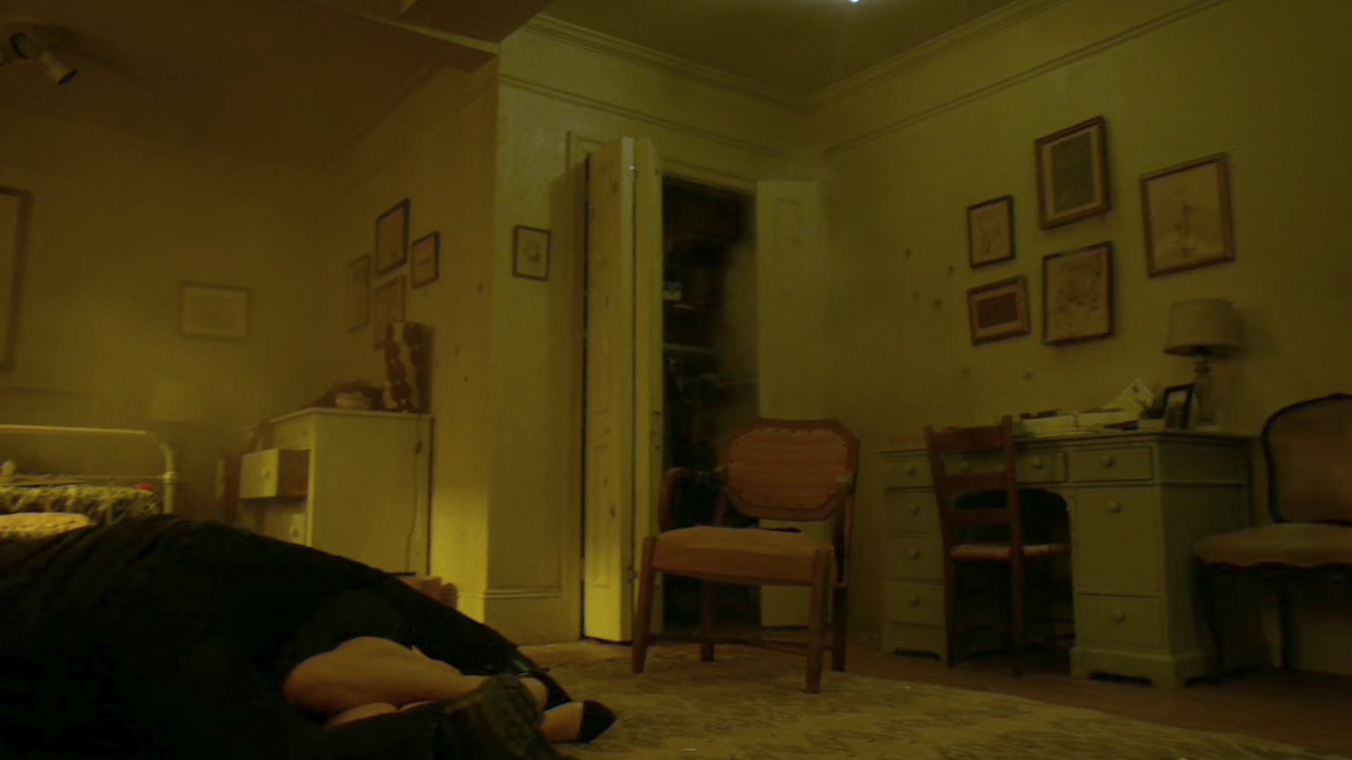 Frank covers Karen as bullet fire destroys her apartment.