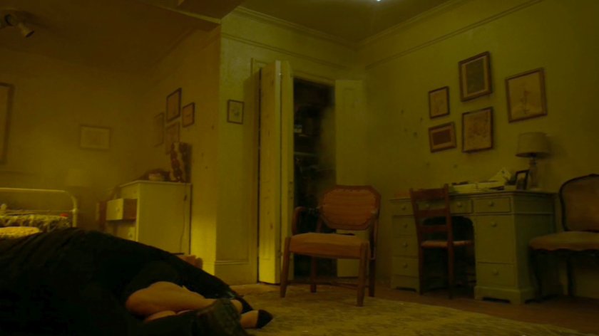 Frank covers Karen as bullet fire destroys her apartment.