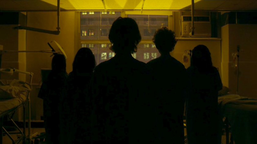 Infected patients silhouetted by window in the remodeled wing of Metro-General.