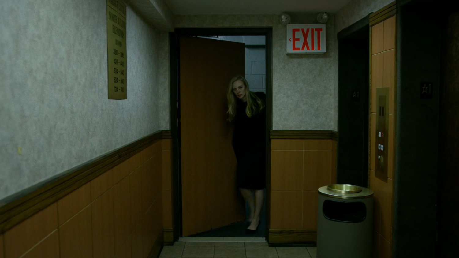 Karen enters lower lobby at the Hotel Travel Inn.