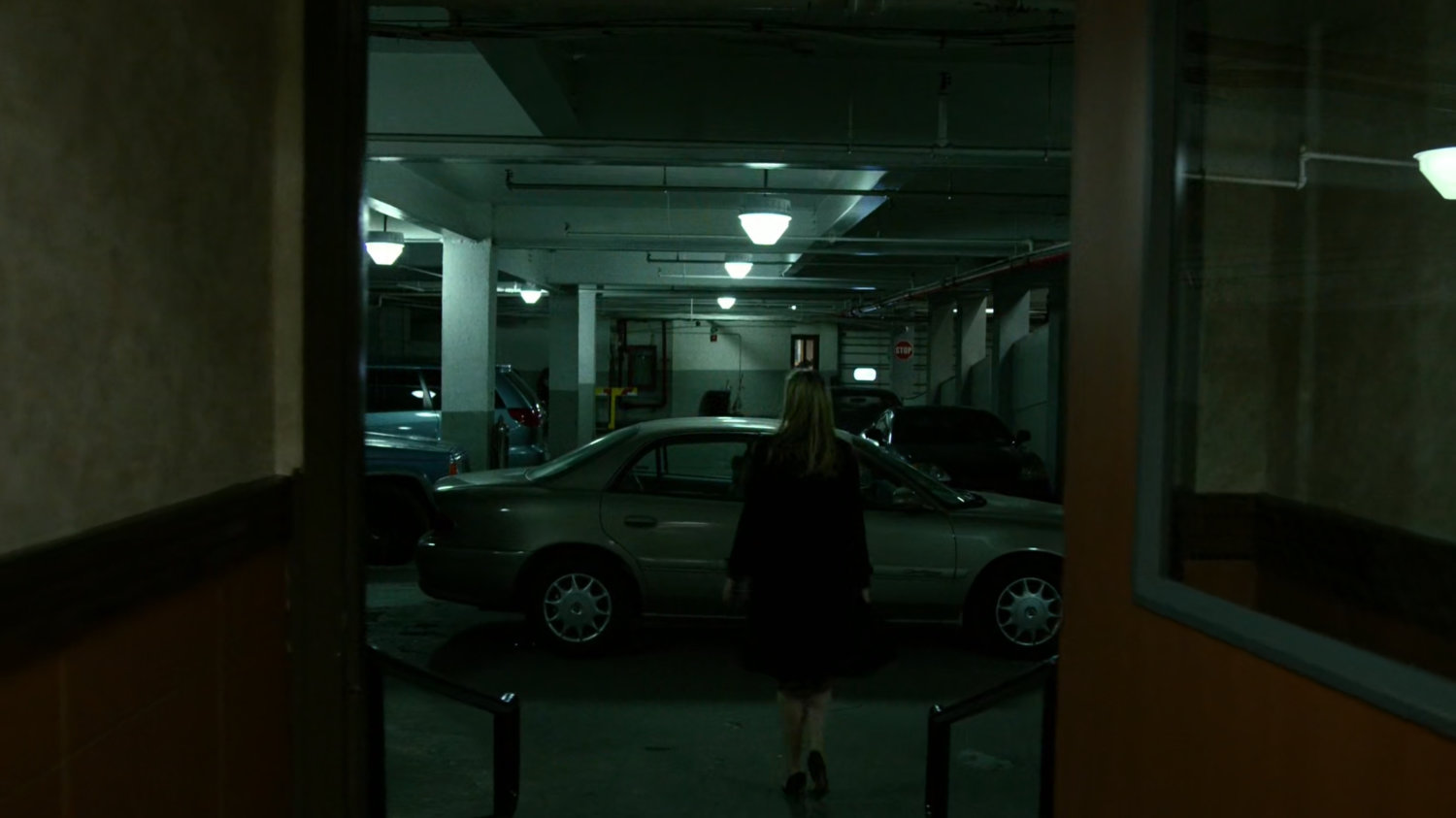 Karen walking into parking garage at the Hotel Travel Inn.